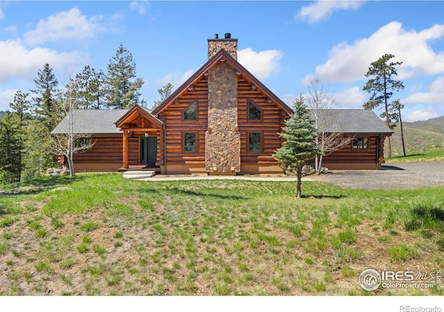 117 Crocus Dr, Bellvue, CO 80512 - log home with a chimney, log exterior, a front lawn, and entry steps