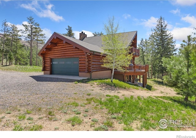 117 Crocus Dr, Bellvue, CO 80512 - view of property exterior featuring log exterior, a garage, a chimney, and a deck