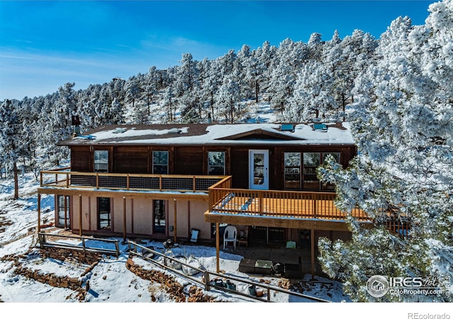 rustic home featuring a deck with mountain view