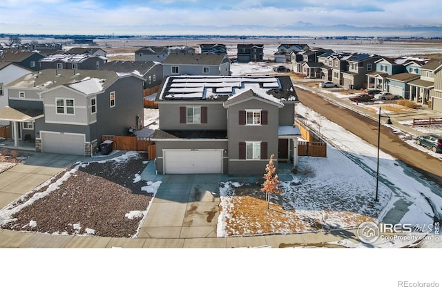 snowy aerial view featuring a residential view