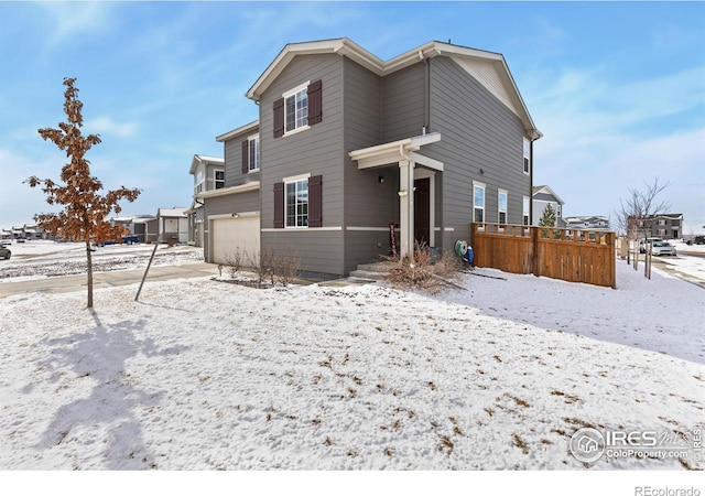 view of front of house featuring fence and an attached garage