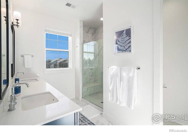 bathroom featuring vanity and a shower with shower door