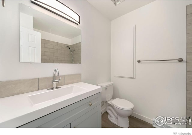 bathroom featuring vanity, toilet, and hardwood / wood-style floors