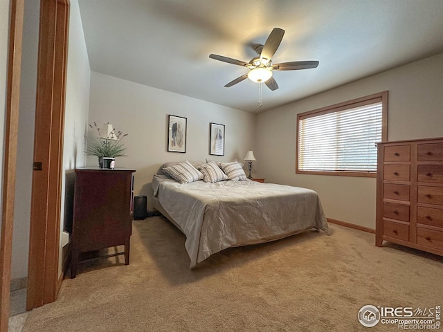 bedroom featuring ceiling fan and carpet