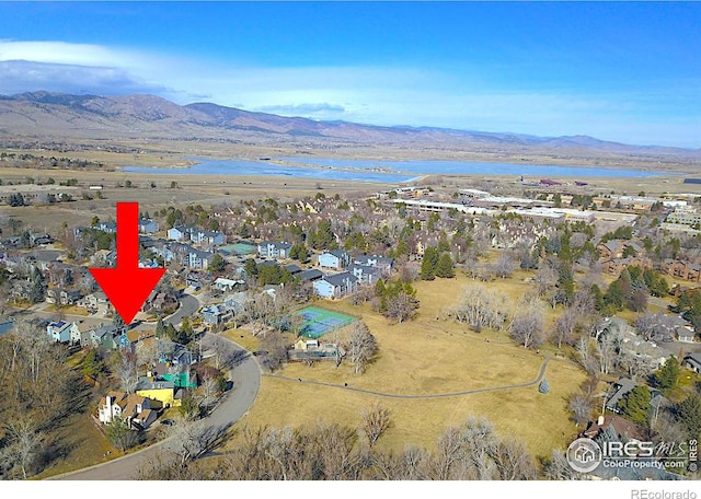 birds eye view of property featuring a water and mountain view