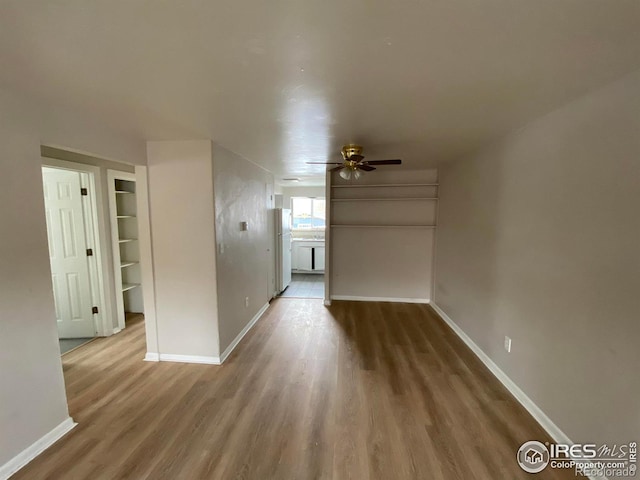 unfurnished living room featuring wood-type flooring and ceiling fan