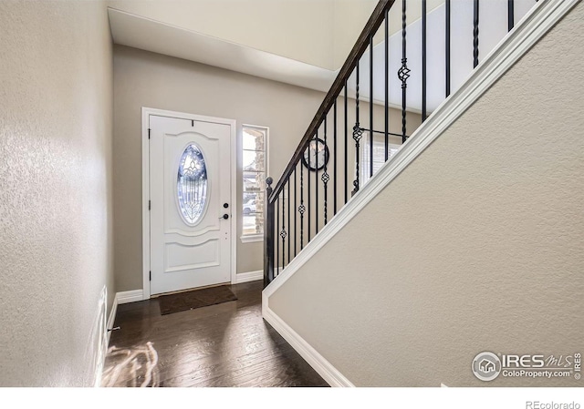 entryway with dark hardwood / wood-style flooring