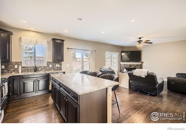 kitchen with tasteful backsplash, a wealth of natural light, dark hardwood / wood-style floors, and a kitchen island