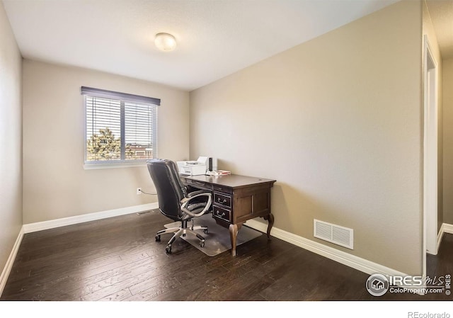 home office with dark hardwood / wood-style flooring