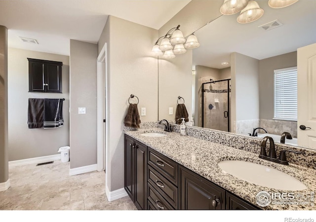 bathroom with a shower with door and vanity