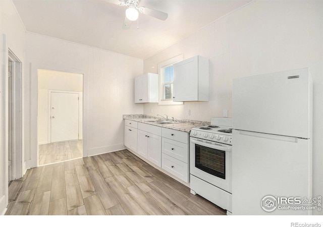 kitchen featuring sink, white appliances, light stone counters, white cabinets, and light wood-type flooring