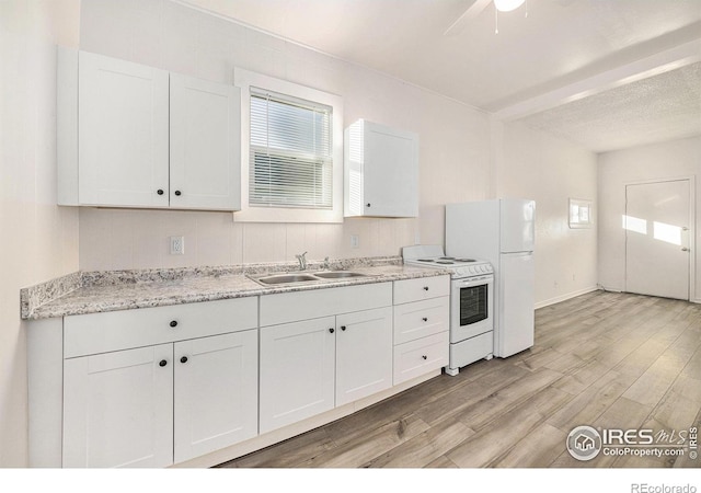 kitchen featuring white cabinetry, sink, white appliances, and light wood-type flooring