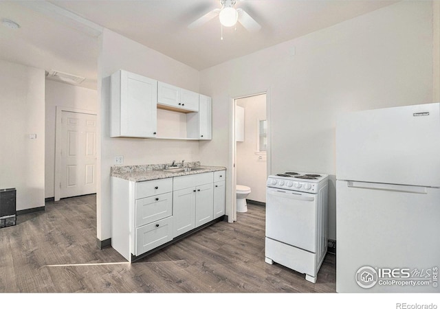 kitchen featuring white appliances, dark hardwood / wood-style floors, sink, and white cabinets