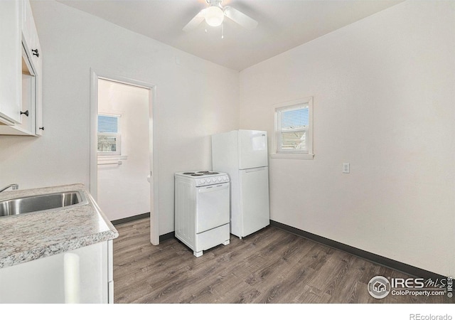 kitchen featuring white appliances, dark hardwood / wood-style flooring, sink, and white cabinets