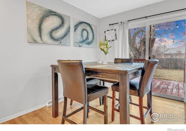 dining area with light hardwood / wood-style floors