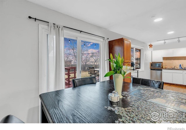 dining space with sink and hardwood / wood-style floors