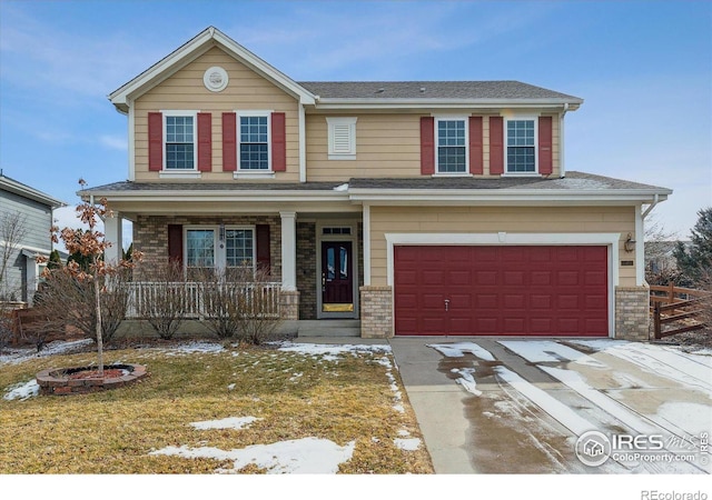 view of front of house with a garage, a front lawn, and covered porch