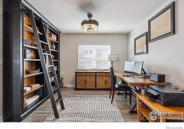 office featuring light hardwood / wood-style flooring and a textured ceiling