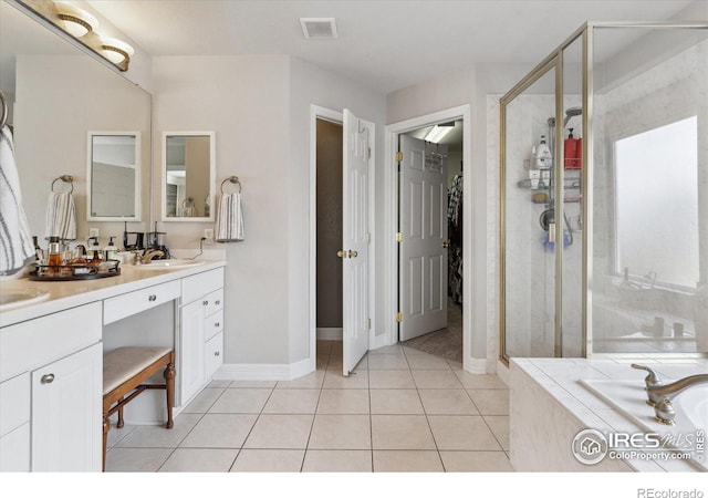 bathroom with vanity, tile patterned flooring, and shower with separate bathtub