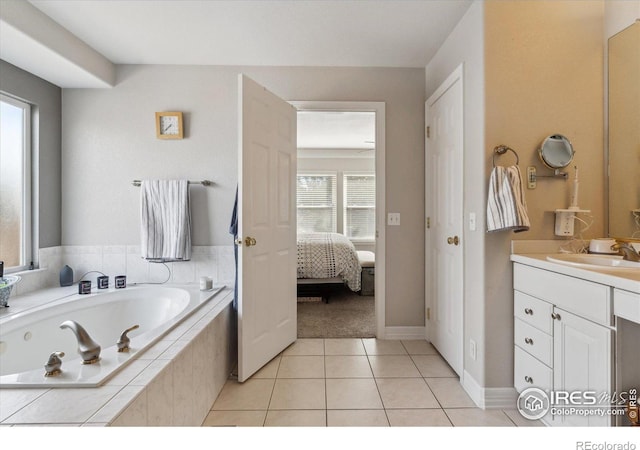 bathroom featuring tile patterned floors, tiled bath, and vanity