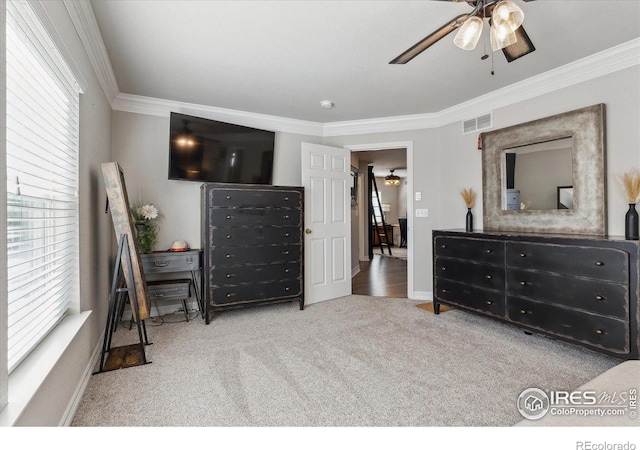 bedroom featuring crown molding, ceiling fan, and light carpet