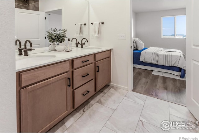 692 Galloway Dr, Johnstown, CO 80534 - ensuite bathroom featuring double vanity and marble finish flooring