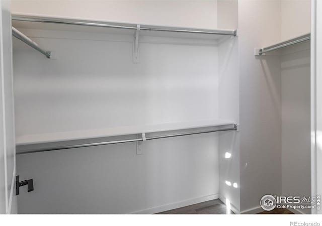 692 Galloway Dr, Johnstown, CO 80534 - spacious closet featuring wood finished floors