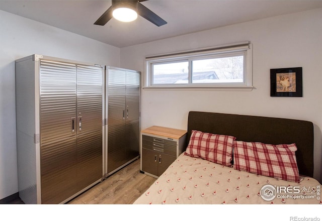 bedroom featuring ceiling fan, a closet, and light hardwood / wood-style flooring