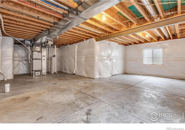 below grade area featuring heating unit and gas water heater