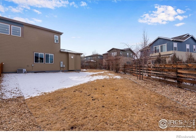 view of yard with fence and central AC unit