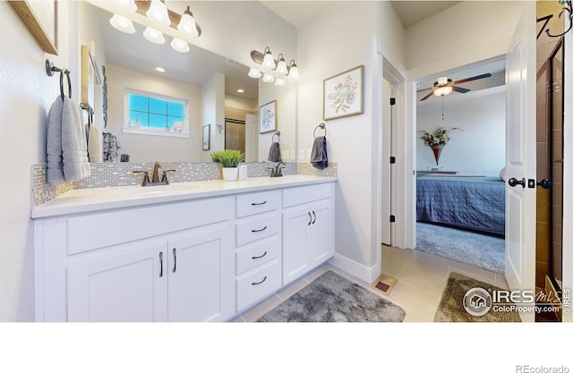 bathroom featuring tile patterned flooring, vanity, decorative backsplash, and ceiling fan