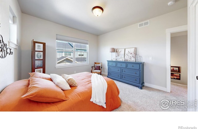 bedroom featuring light carpet