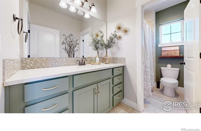 bathroom with vanity, backsplash, and toilet