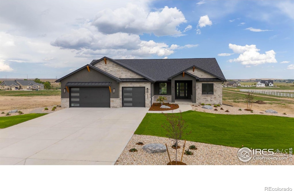 craftsman-style house featuring a front yard and a garage