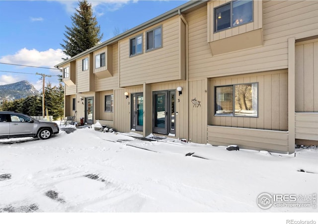 townhome / multi-family property featuring a mountain view and board and batten siding