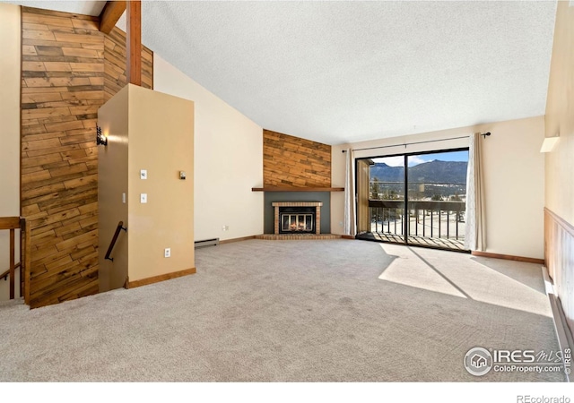 unfurnished living room featuring a textured ceiling, carpet floors, wooden walls, a baseboard radiator, and a brick fireplace