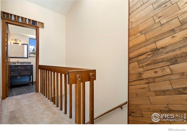 staircase featuring tile patterned flooring and carpet