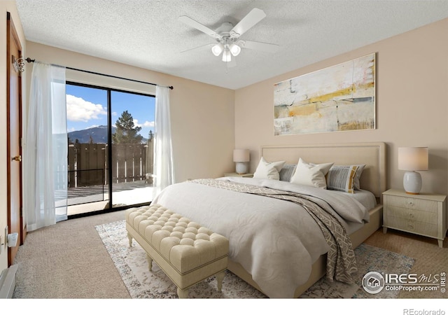 bedroom featuring a textured ceiling, carpet, ceiling fan, and access to outside