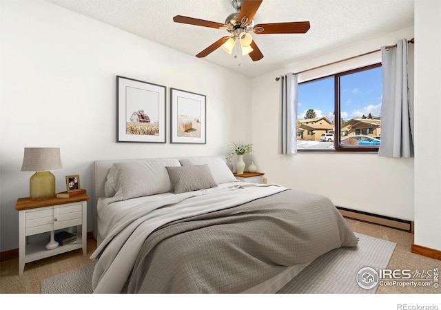 carpeted bedroom with a textured ceiling, baseboards, and a baseboard radiator