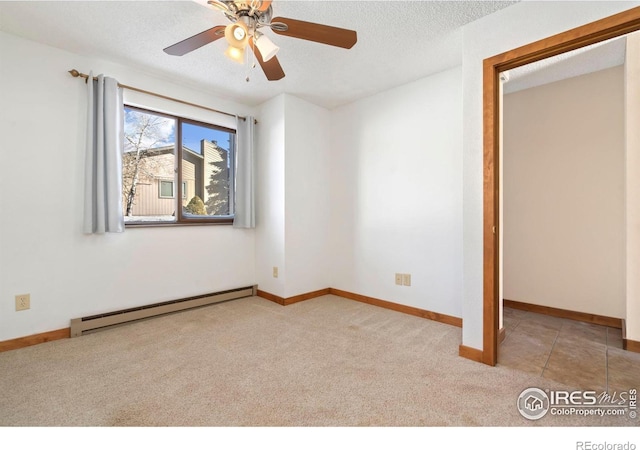 unfurnished bedroom with a textured ceiling, carpet flooring, baseboards, and a baseboard radiator