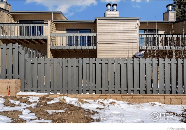 snow covered gate with fence