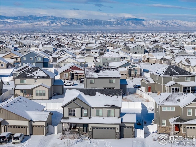 snowy aerial view with a mountain view