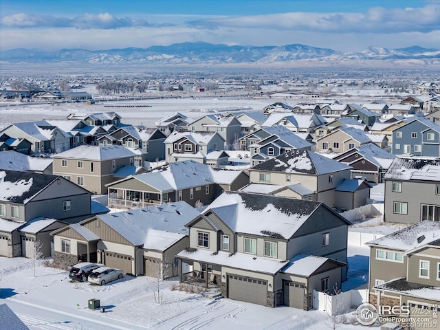 snowy aerial view with a mountain view