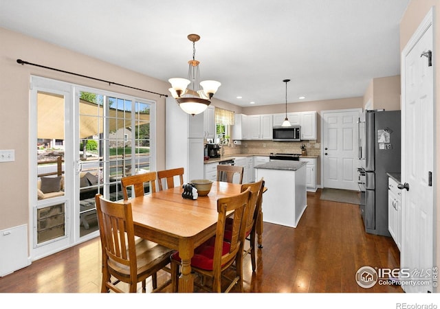 dining room with a chandelier and dark hardwood / wood-style flooring