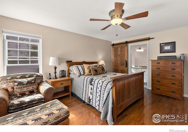 bedroom featuring ceiling fan, a barn door, and dark hardwood / wood-style flooring