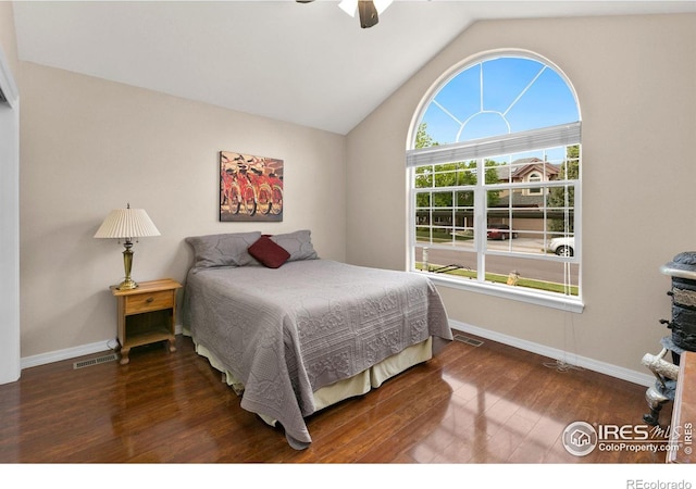 bedroom featuring lofted ceiling, dark wood-type flooring, and ceiling fan