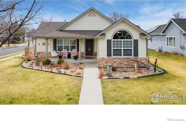 1421 Snipe Ln, Fort Collins, CO 80524 - view of front of house with stone siding, a shingled roof, a porch, and a front yard