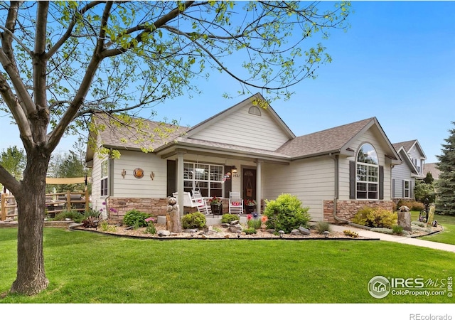 1421 Snipe Ln, Fort Collins, CO 80524 - view of front facade with stone siding, a porch, and a front yard