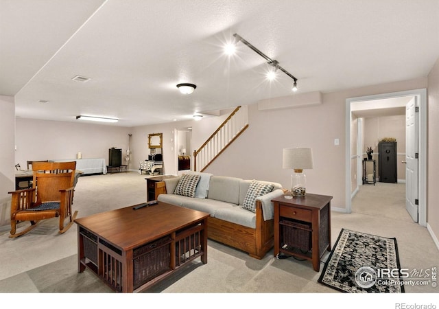 1421 Snipe Ln, Fort Collins, CO 80524 - living room with light colored carpet, track lighting, visible vents, and stairway