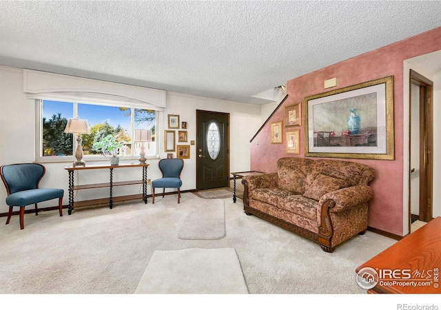 carpeted living room with a textured ceiling and baseboards